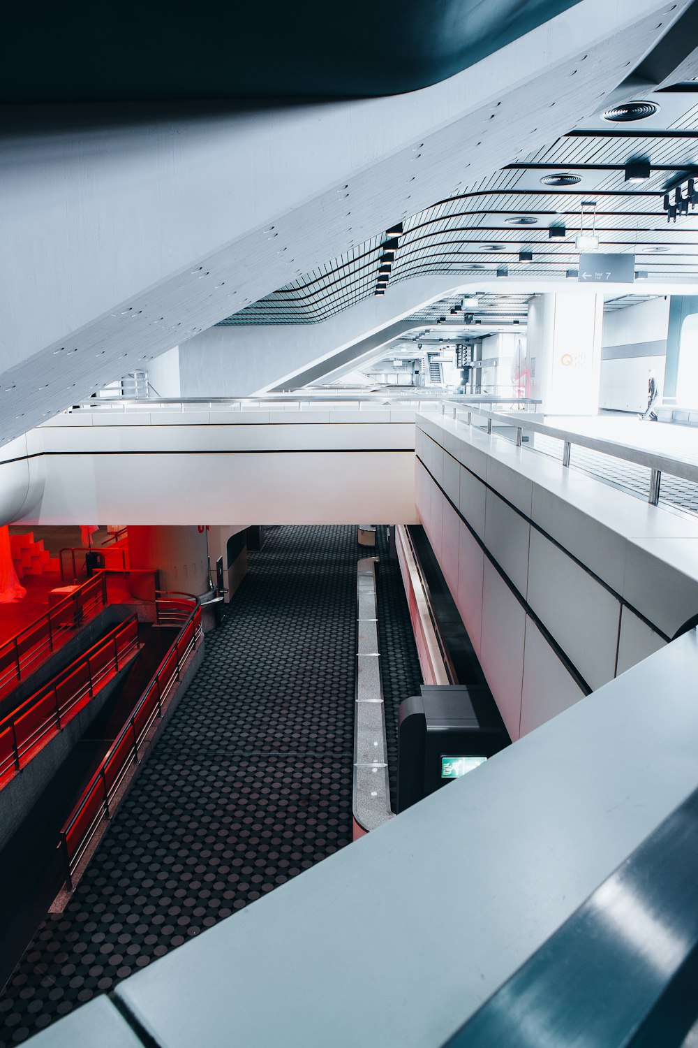 a long white and red escalator