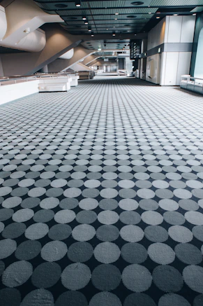 a large room with a large group of grey balls in it