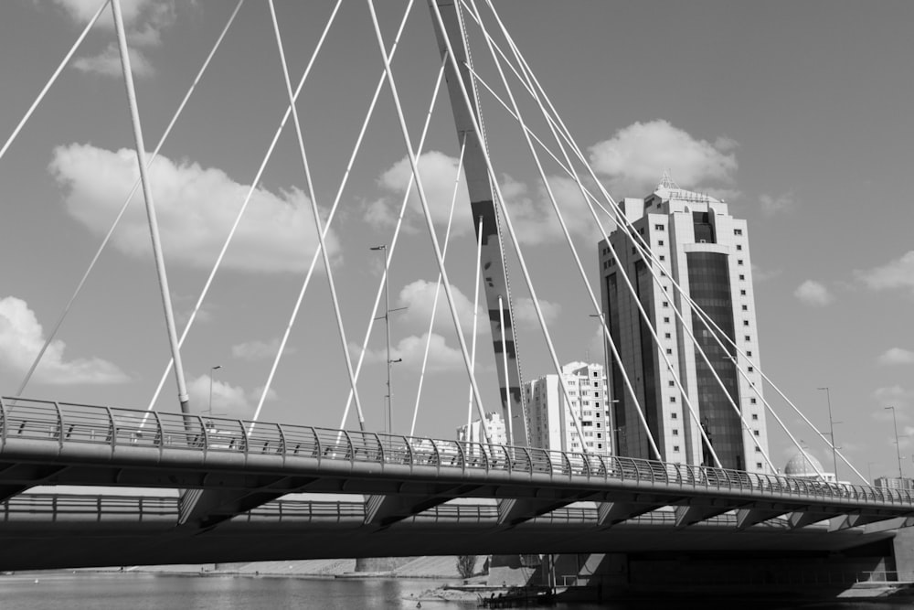 a bridge over water with a city in the background