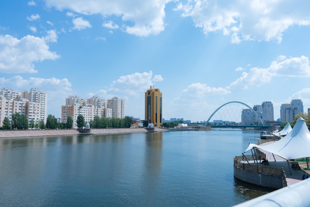 a body of water with a bridge and buildings in the background