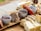 Close-up of artisanal bread and local jams displayed on a wooden table.