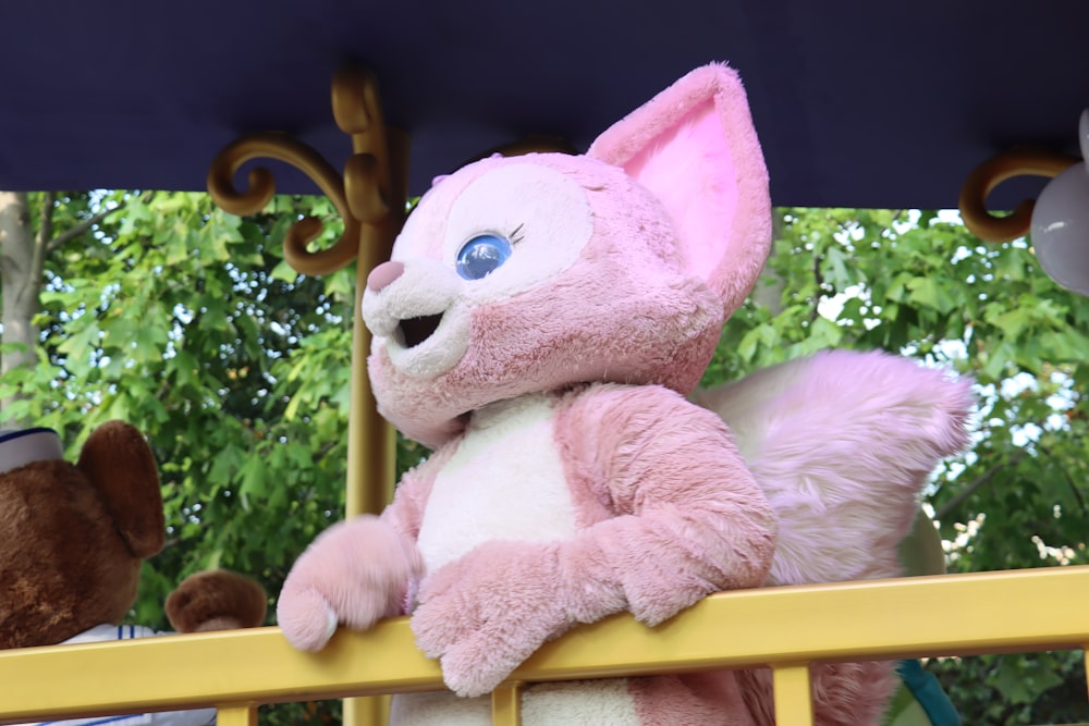 a stuffed animal on a railing