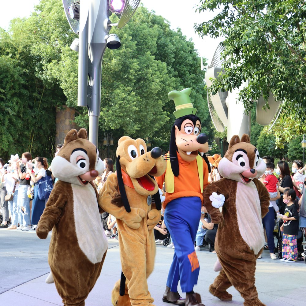 a group of people in clothing walking down a street