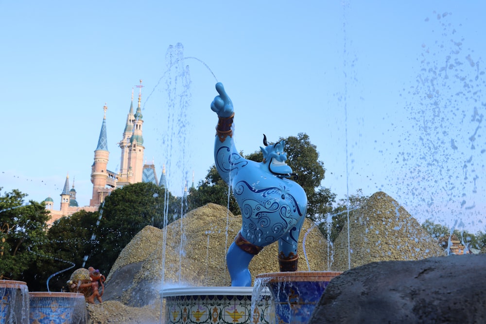 a statue of a man holding a sword in front of a fountain