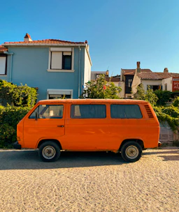 A sleek van parked in front of a sunny Naples street, ready for delivery.