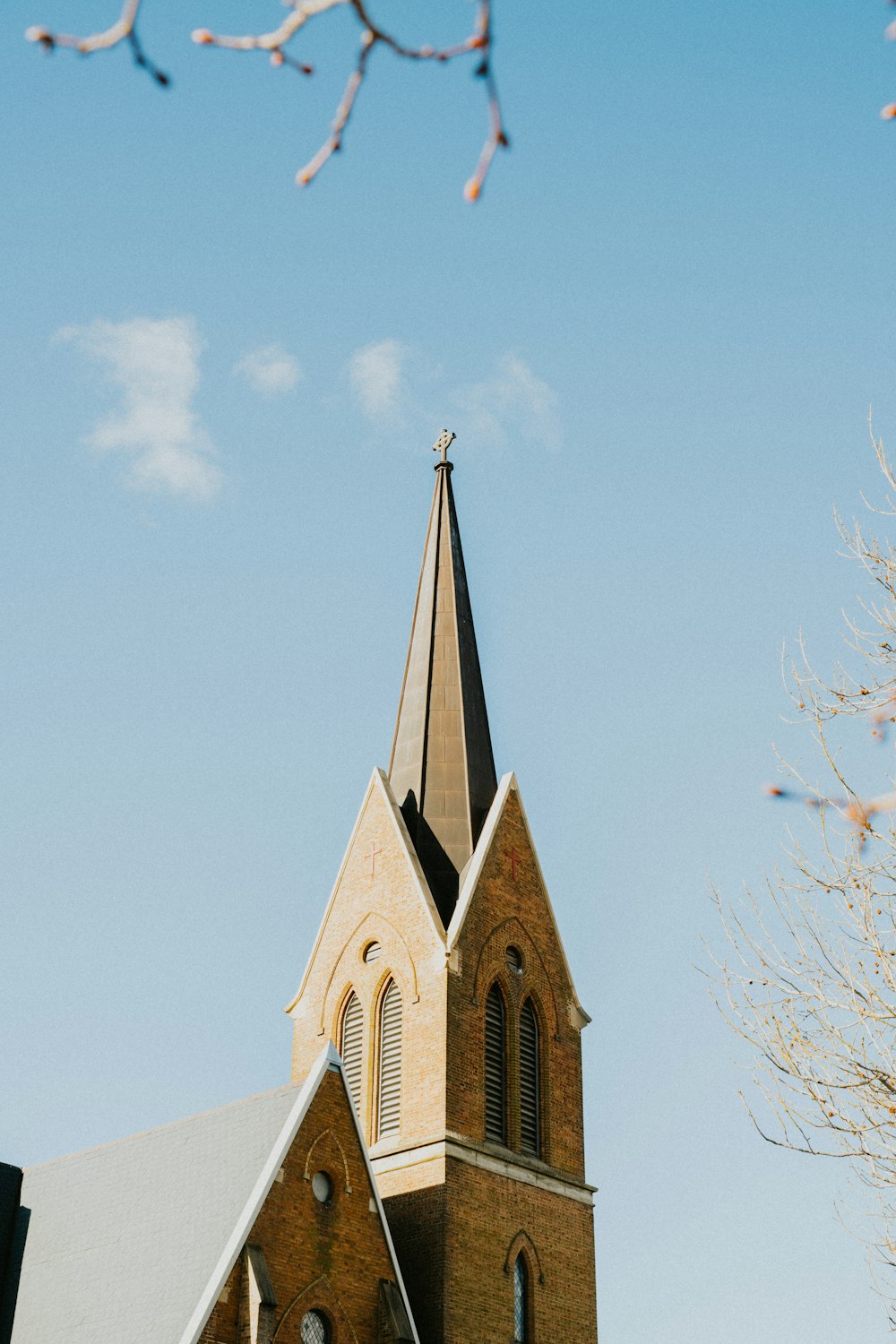 a church steeple with a cross on top