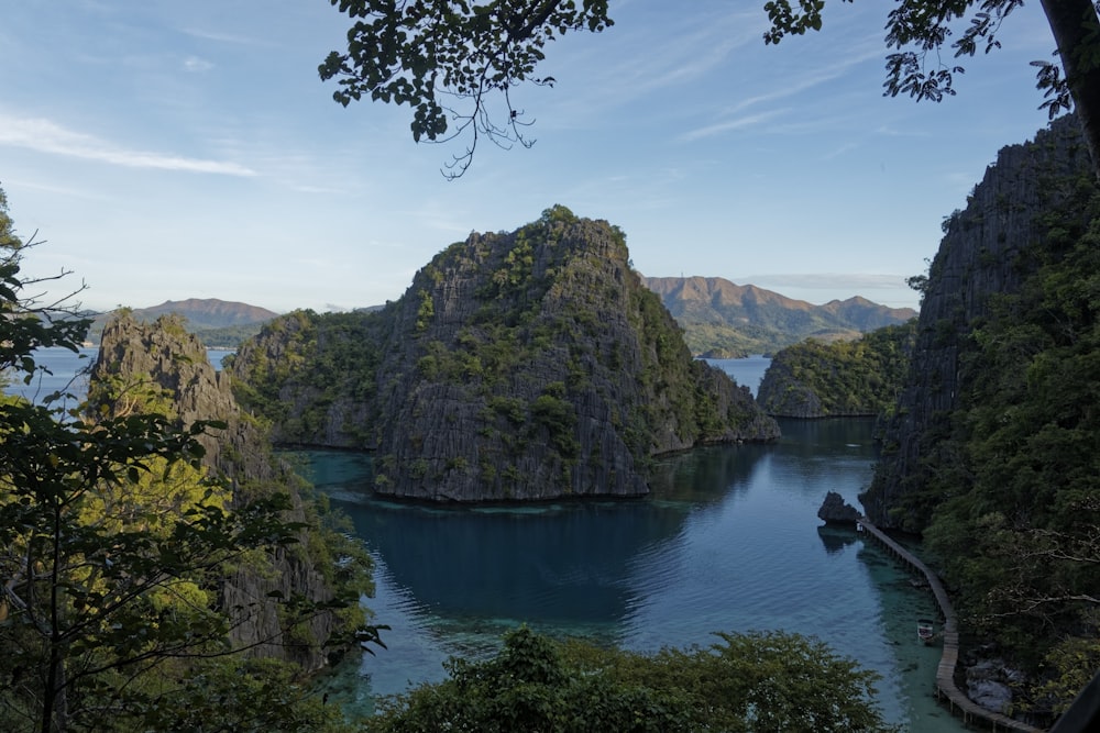 a body of water with a rock structure in the middle