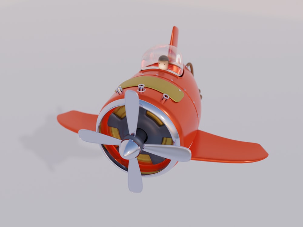um avião de brinquedo com uma hélice vermelha e branca