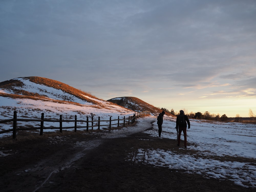 a group of people walking on a snowy road