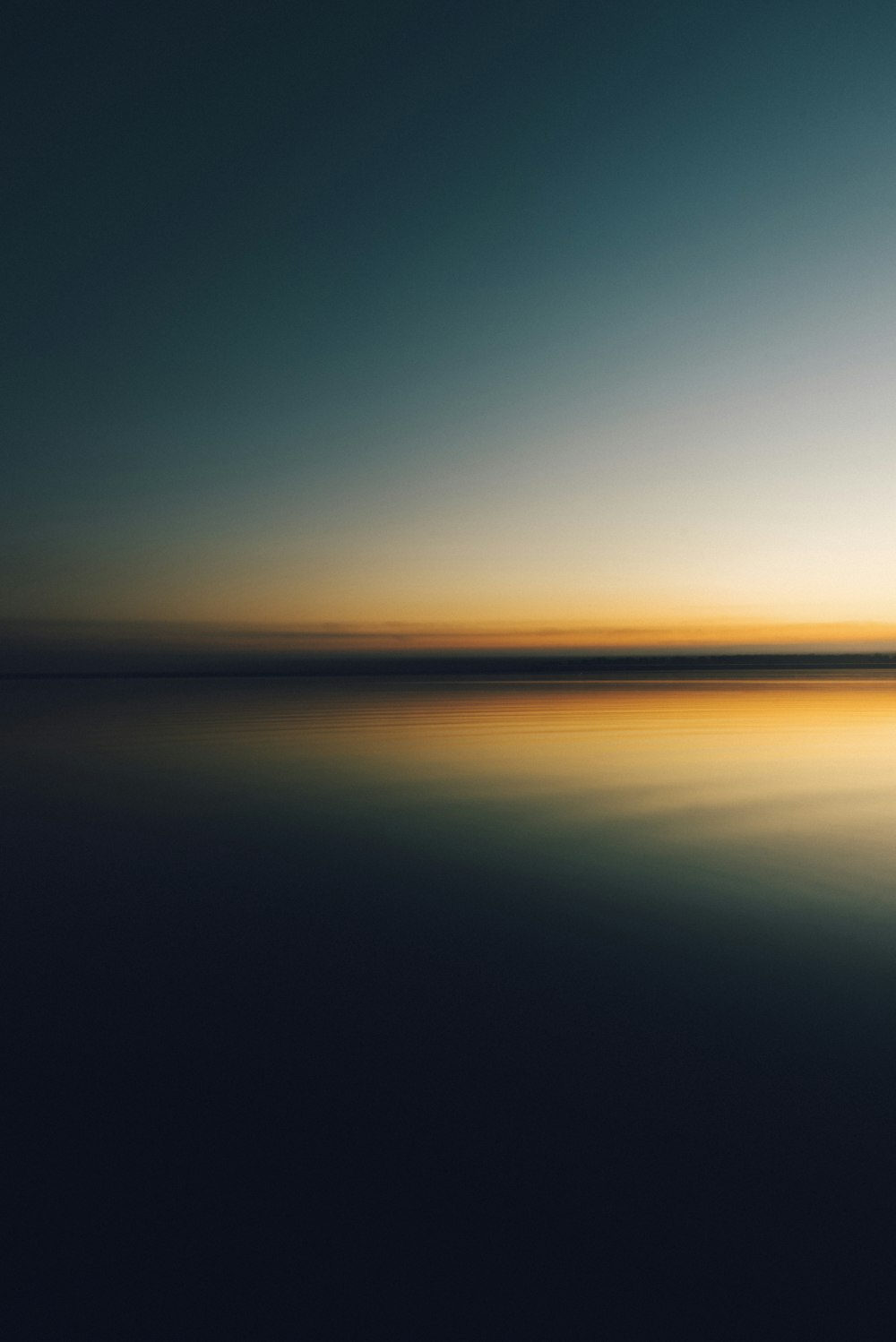 a body of water with a sunset