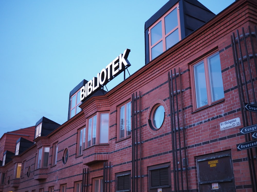 a brick building with a sign on it