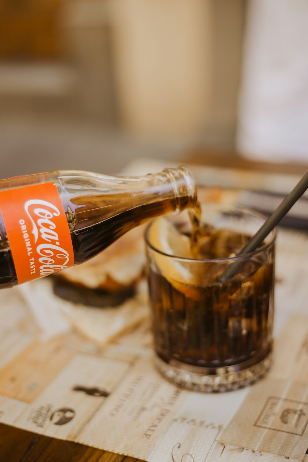 a glass of brown liquid with a spoon on a table