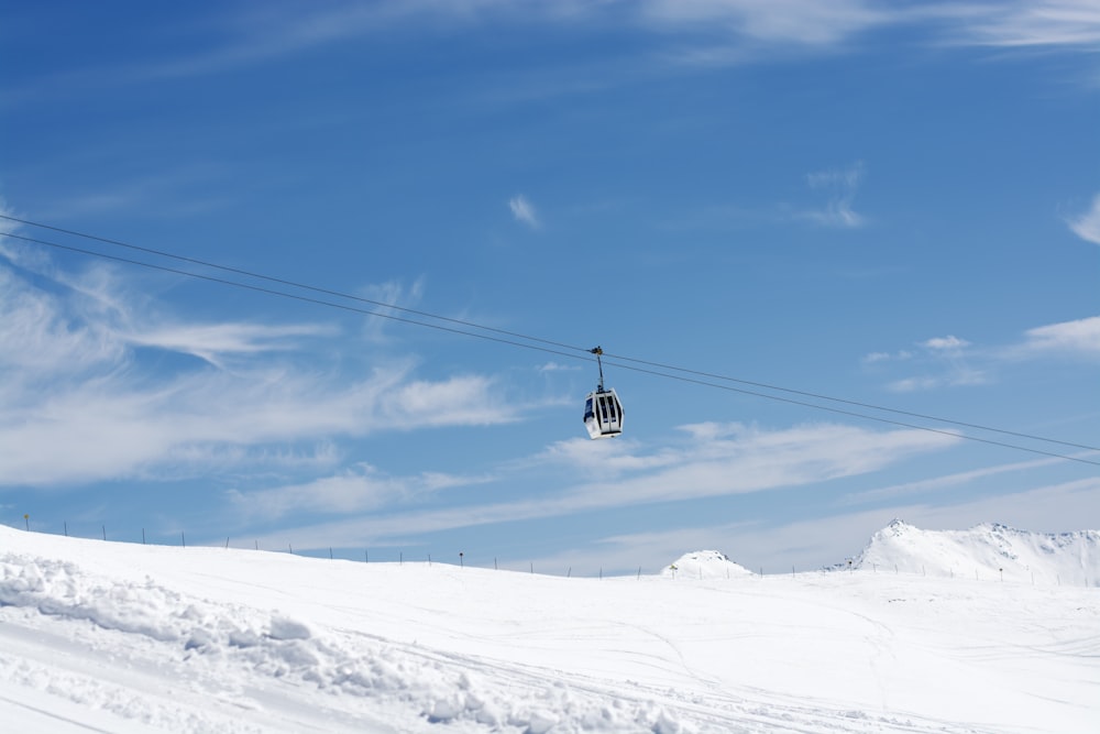 a ski lift going up a snowy mountain