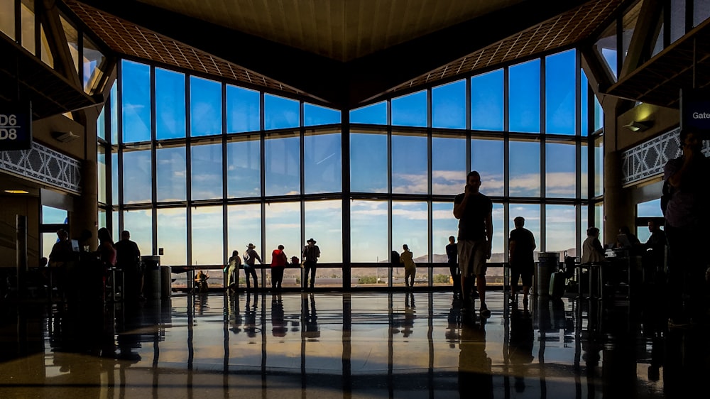 a group of people in a large building with large windows