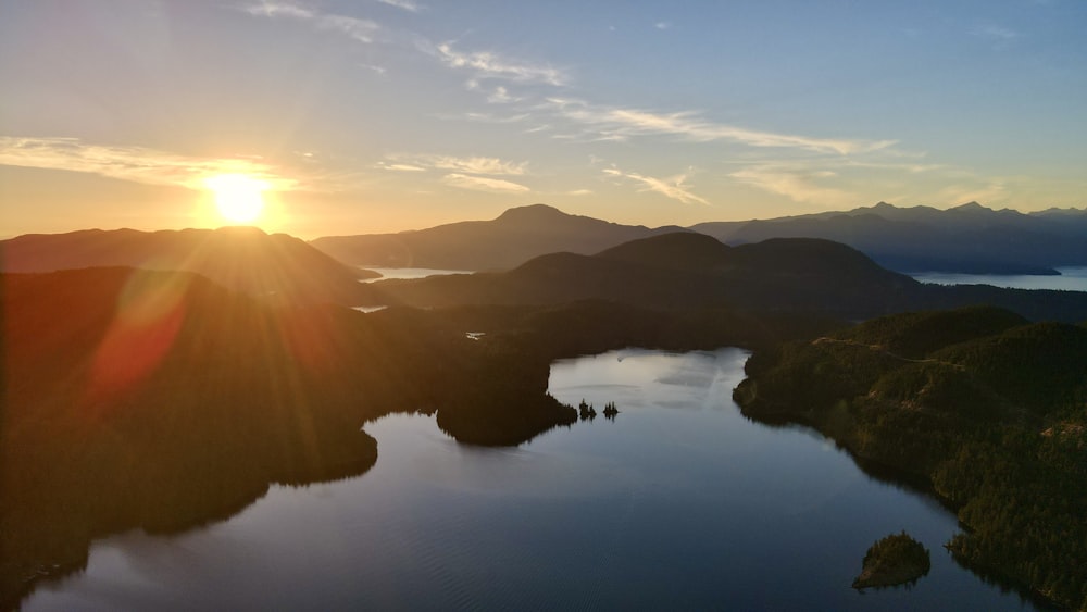 a body of water with hills and trees around it