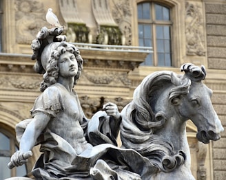 a statue of a person riding a horse