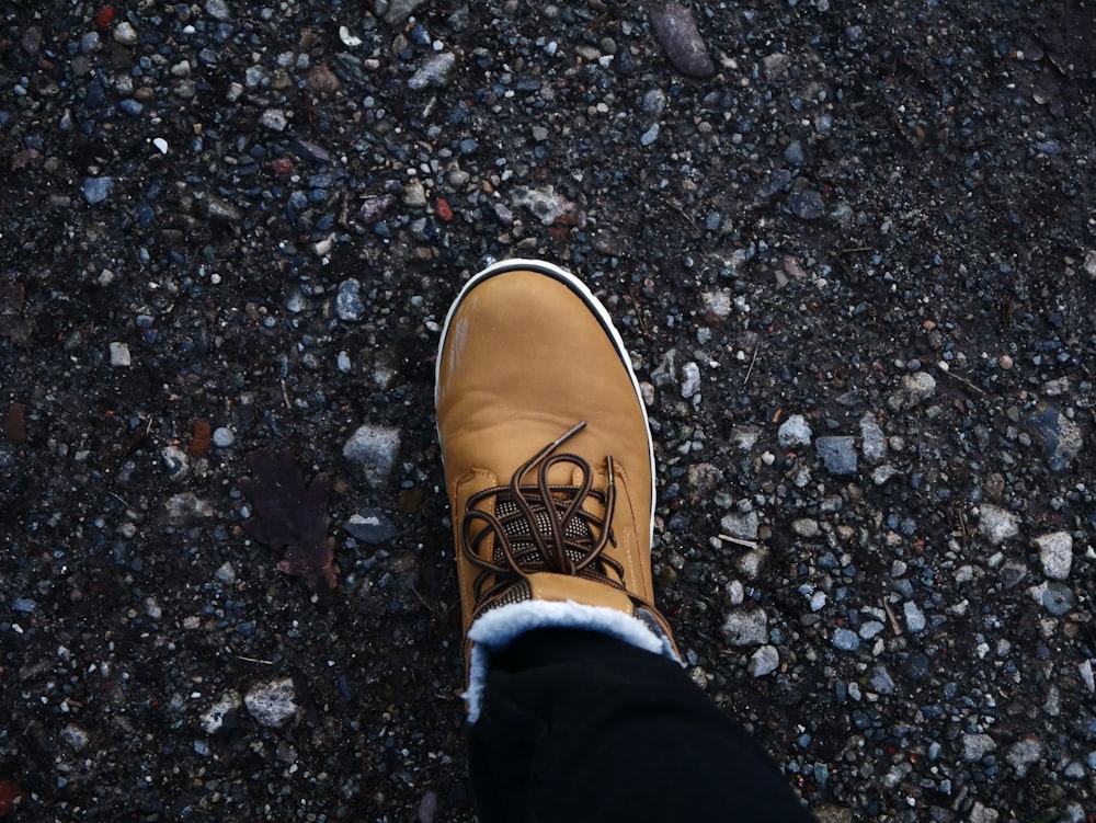 a person's feet on a rocky surface