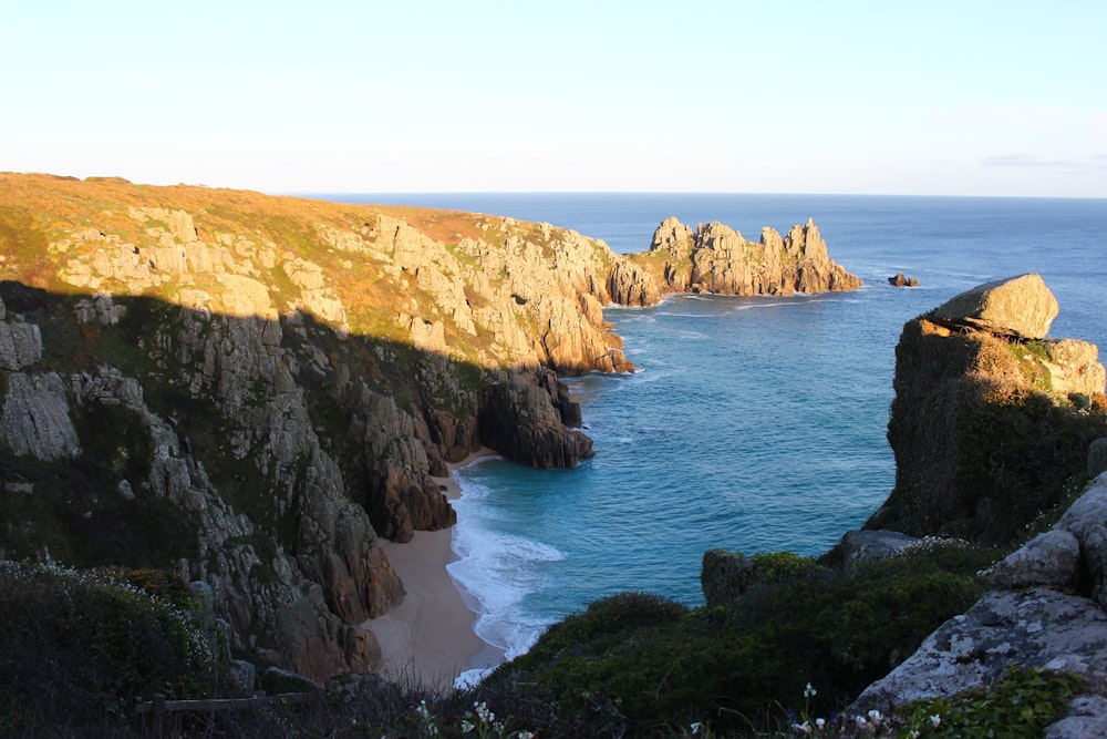 a rocky cliff overlooking a body of water