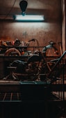 Mechanic tuning a motorcycle engine in a bright, organized workshop.