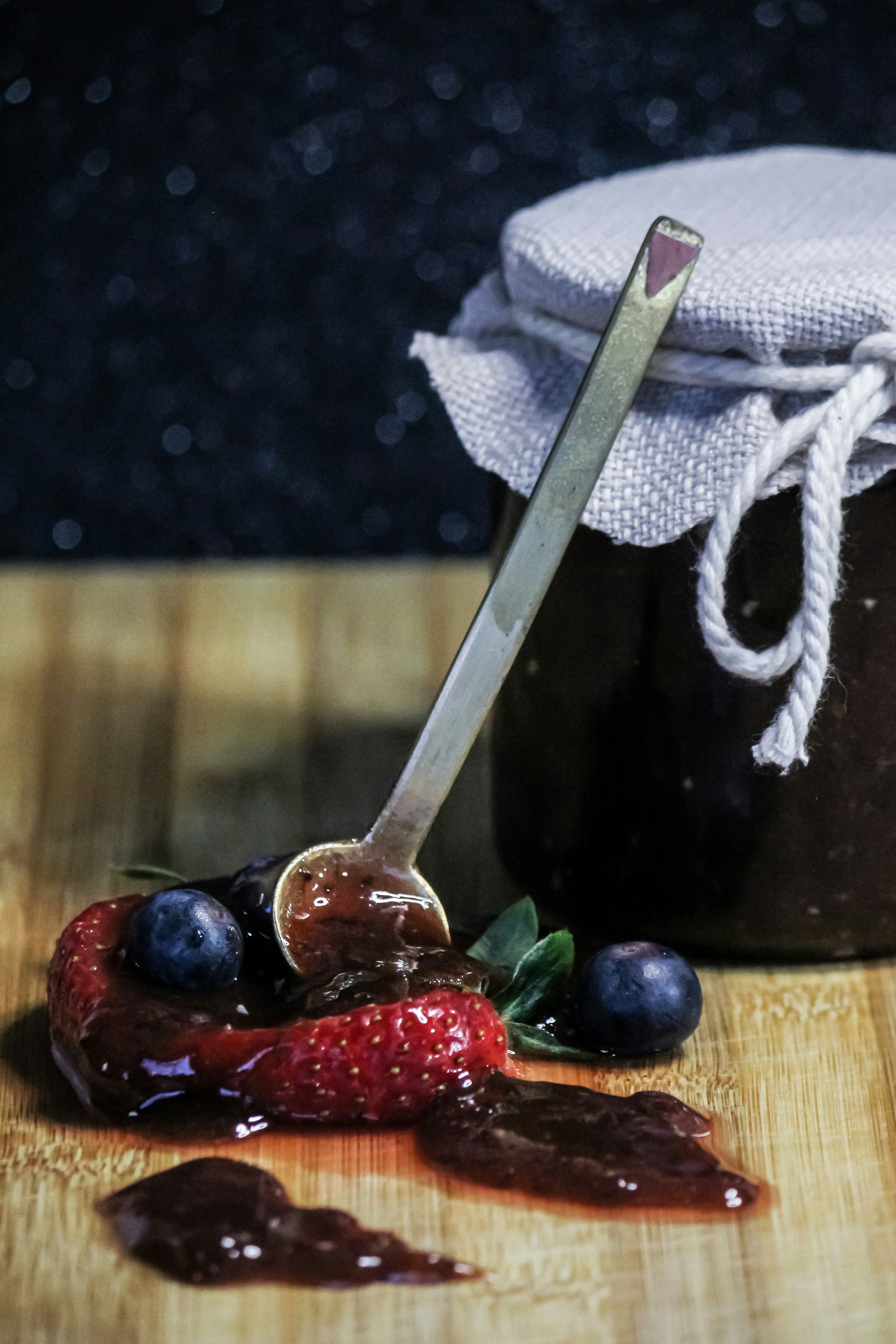 a knife on a cutting board with fruit and a knife