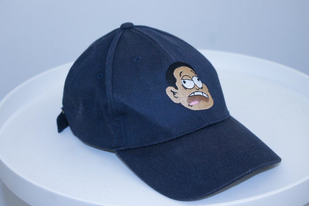 a blue hat with a man's face on it