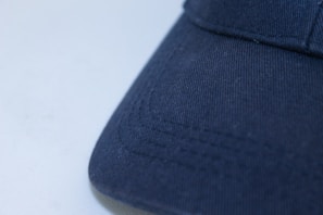 Close-up of a navy blue hoodie fabric texture with visible stitching details