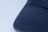 Close-up image of finely stitched school uniform fabric in navy blue and golden yellow.