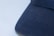 Close-up image of finely stitched school uniform fabric in navy blue and golden yellow.