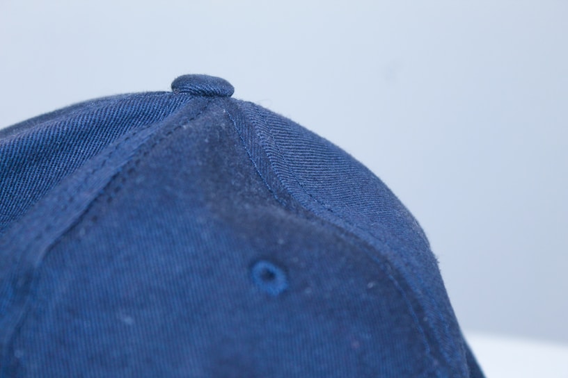 A close-up shot of a softbrimcap baseball cap showing the fine stitching and fabric texture under natural light.