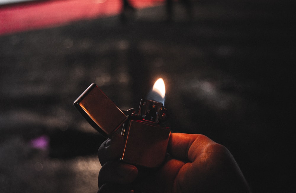 a hand holding a lighter