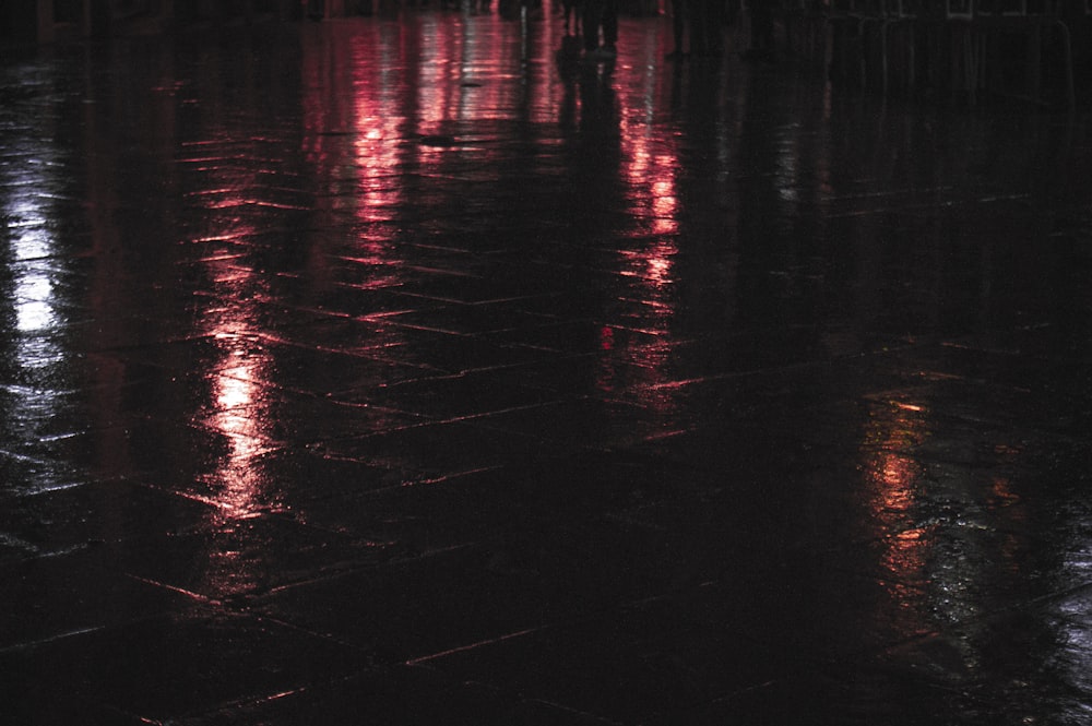 a wet surface with a reflection of a person in it
