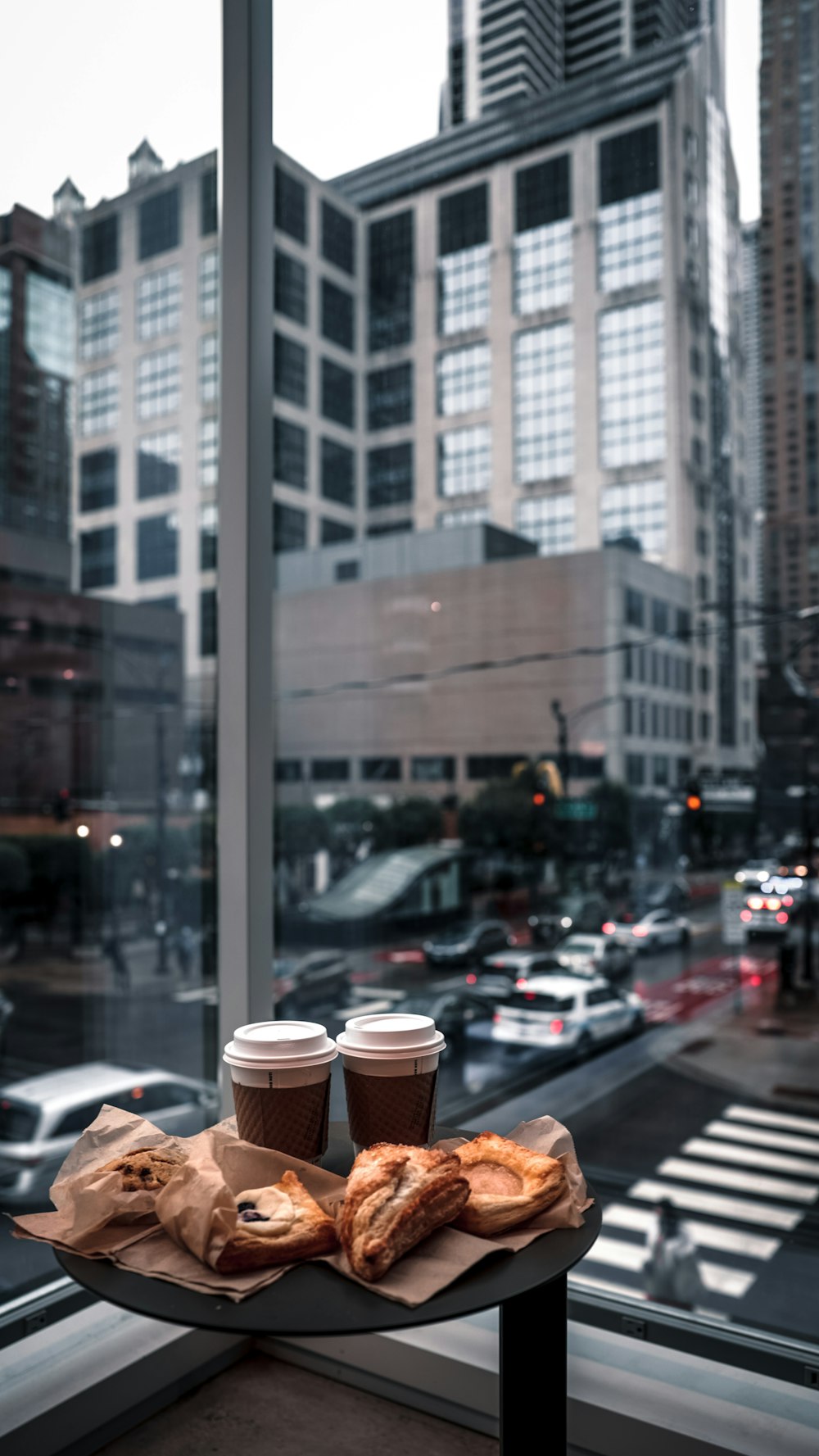 a table with food and drinks on it by a window