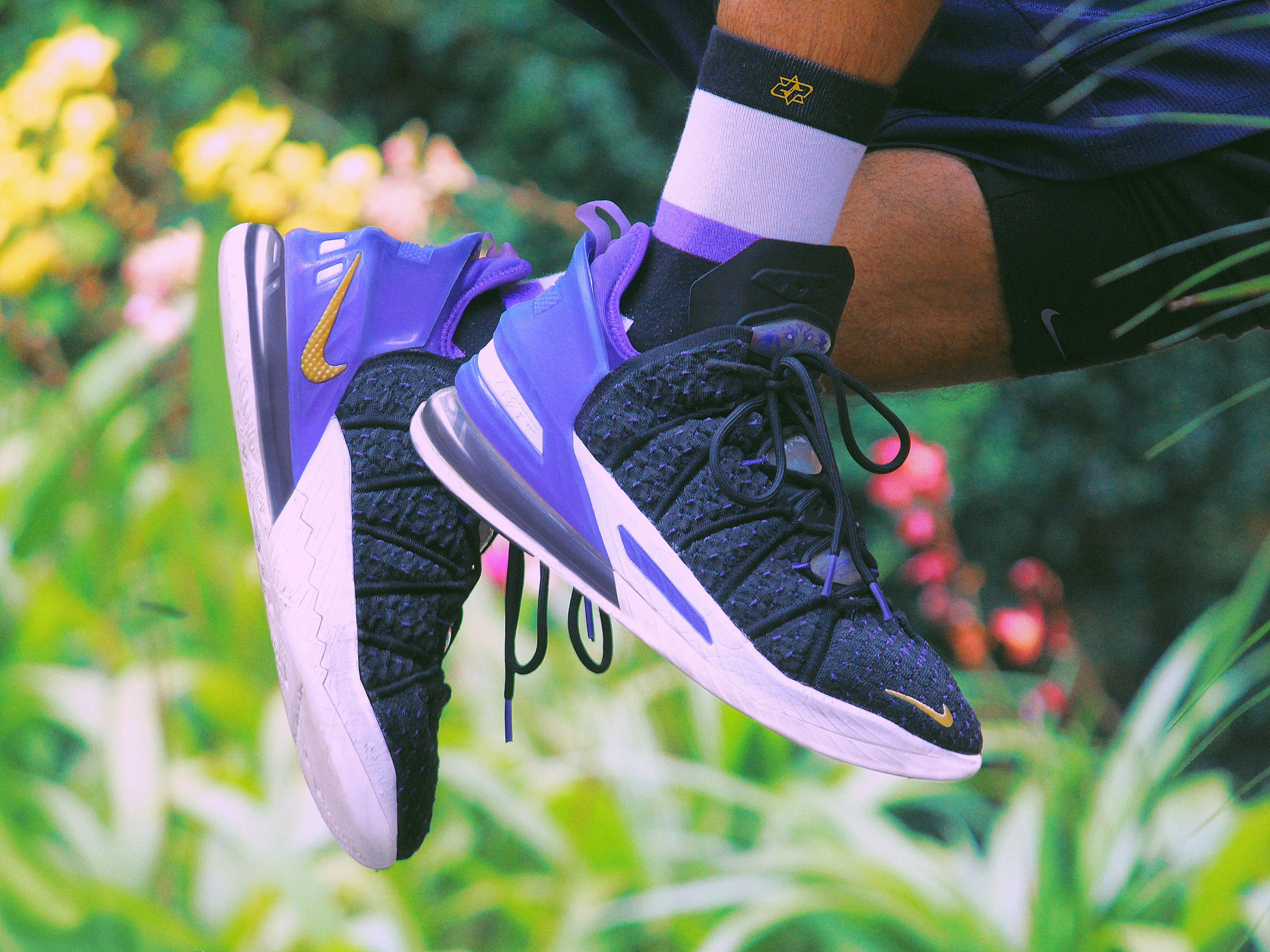 I’ve been using the Nike Lebron 18 “Lakers” for the last one year straight, and I gotta say that, I’m impressed!! Photo by Abhay Siby Mathew. The Nike LeBron 18 ‘Lakers’ dresses LeBron James’ eighteenth signature shoe in the signature colors of Los Angeles’ storied NBA franchise. A mostly black finish is utilized on the KnitPosite 2.0 upper, accented with purple fibers that match the semi-translucent TPU heel counter. Swoosh branding on the forefoot and medial heel shines in metallic gold. The sneaker rides on a midsole that houses a full-length Zoom Air unit, its back half nestled within the visible Max Air unit in the heel.