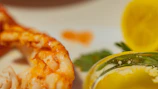 Detailed shot of a lobster tail sizzling on the grill, highlighting textures and fire.