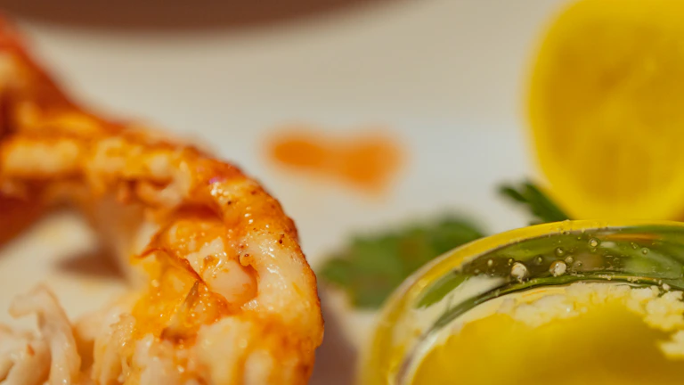 Detailed shot of a lobster tail sizzling on the grill, highlighting textures and fire.