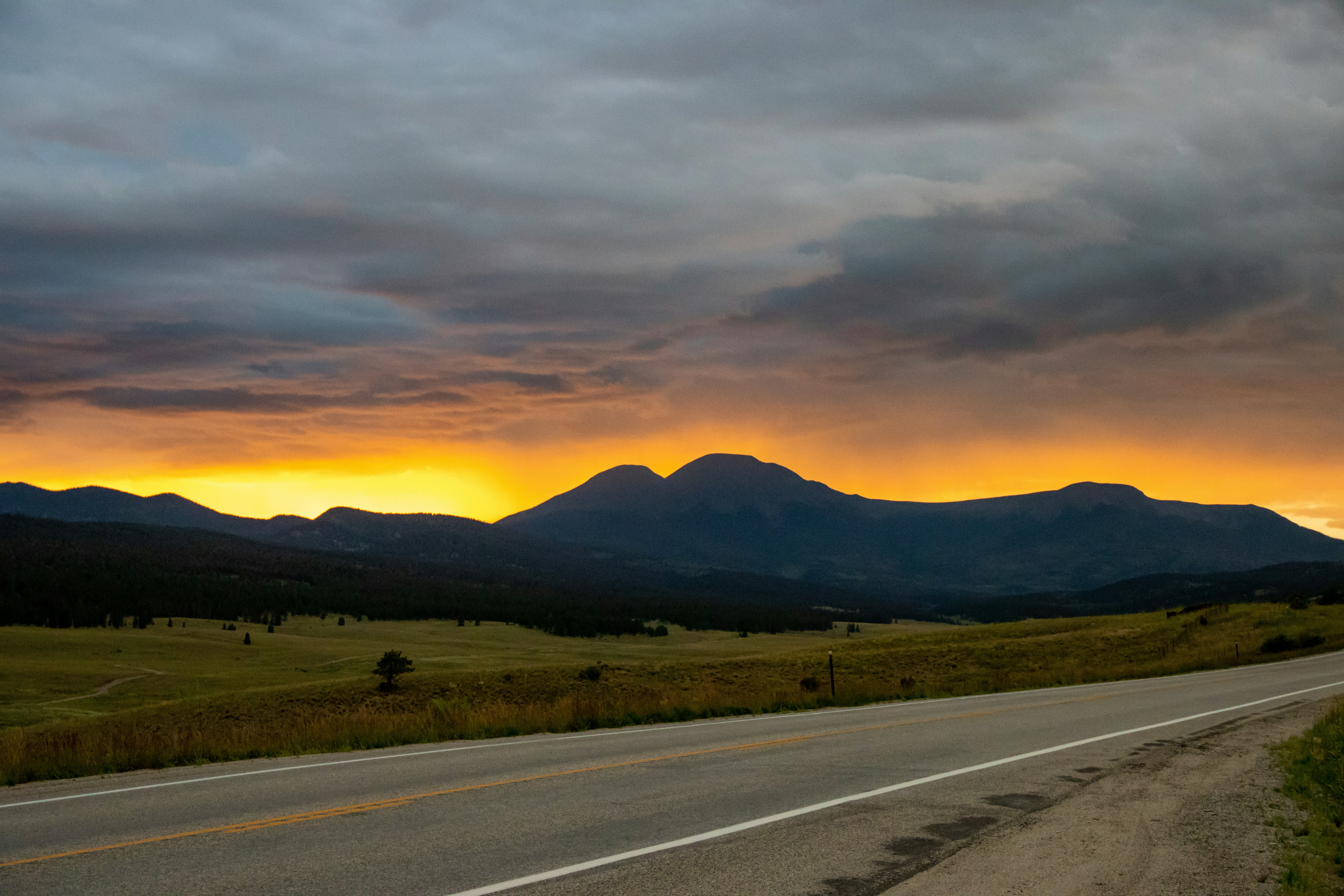 a road with mountains in the background