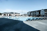 A clean condominium pool area with neatly maintained water and surrounding deck.