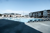 Well-maintained commercial pool sparkling under clear skies.