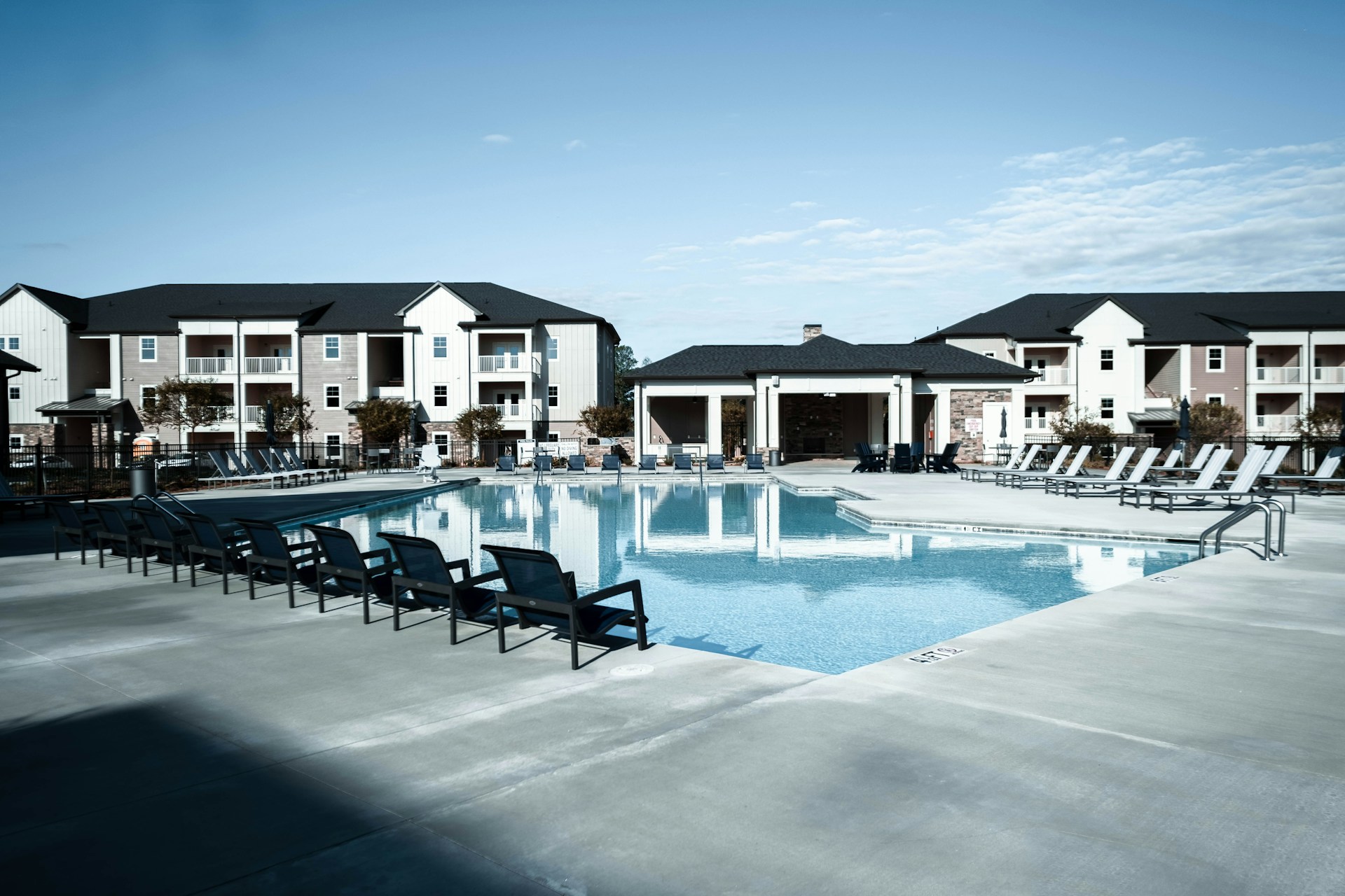 a swimming pool with chairs around it