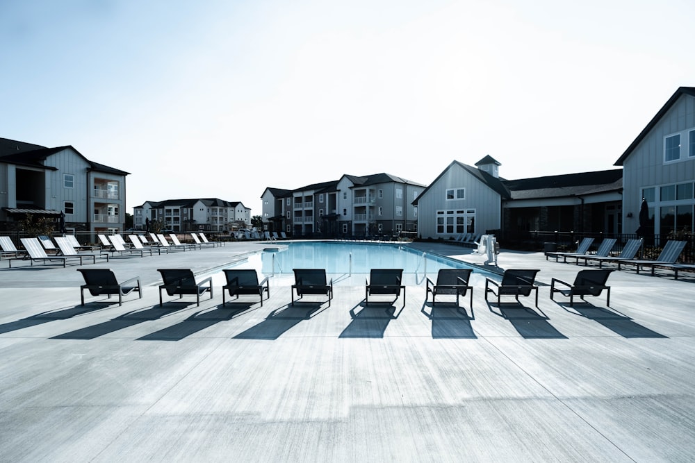 a pool with chairs around it