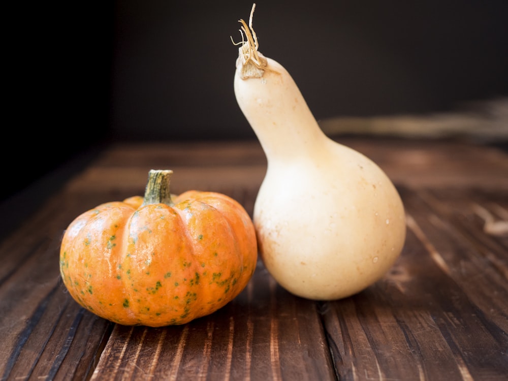 a pear and a squash on a table