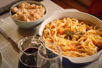 a plate of pasta and a bowl of soup