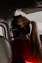 Close-up of a customer support agent assisting a traveler via headset.