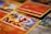 A close-up shot of various Pokémon trading cards laid out, with the focus on a Charmander card. The cards have vibrant and colorful illustrations featuring Pokémon characters and associated game stats.