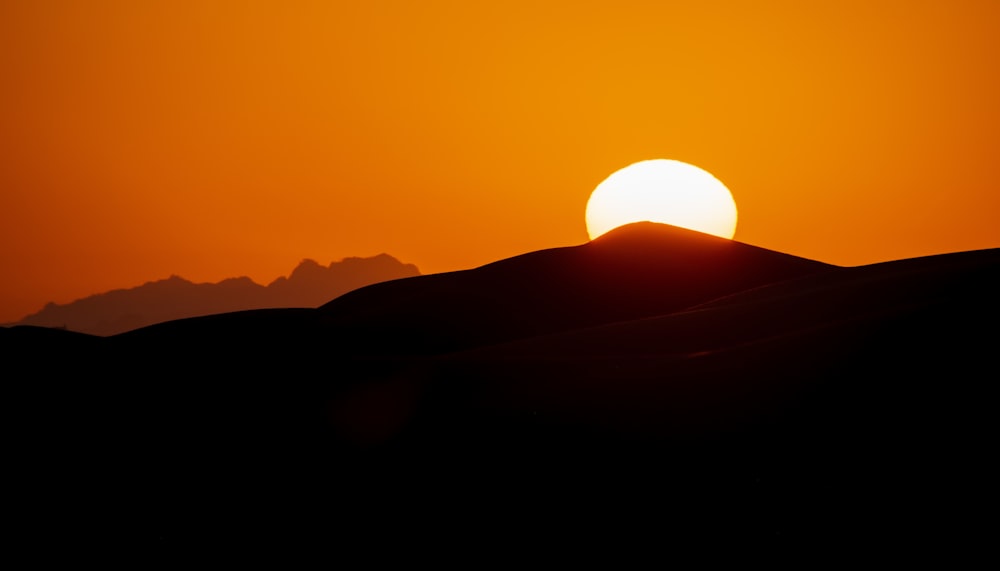 a sunset over a mountain