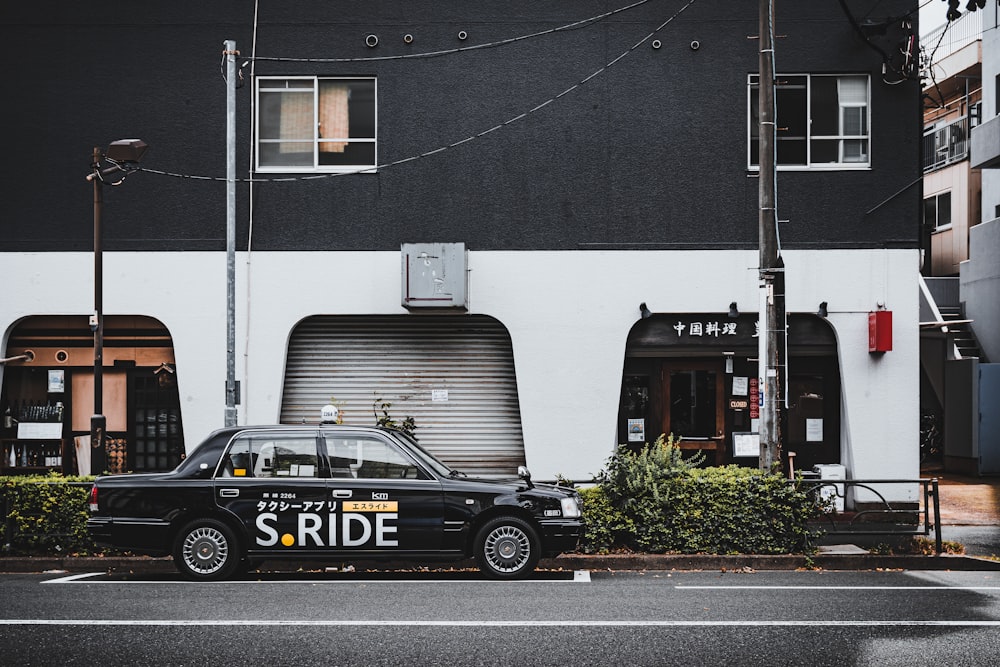 a black car with a trailer