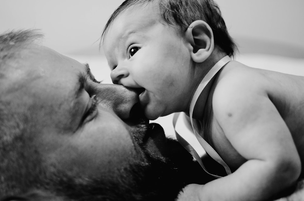 a man kissing a baby