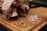 A close-up of a wooden board filled with various biltong slices and spices.