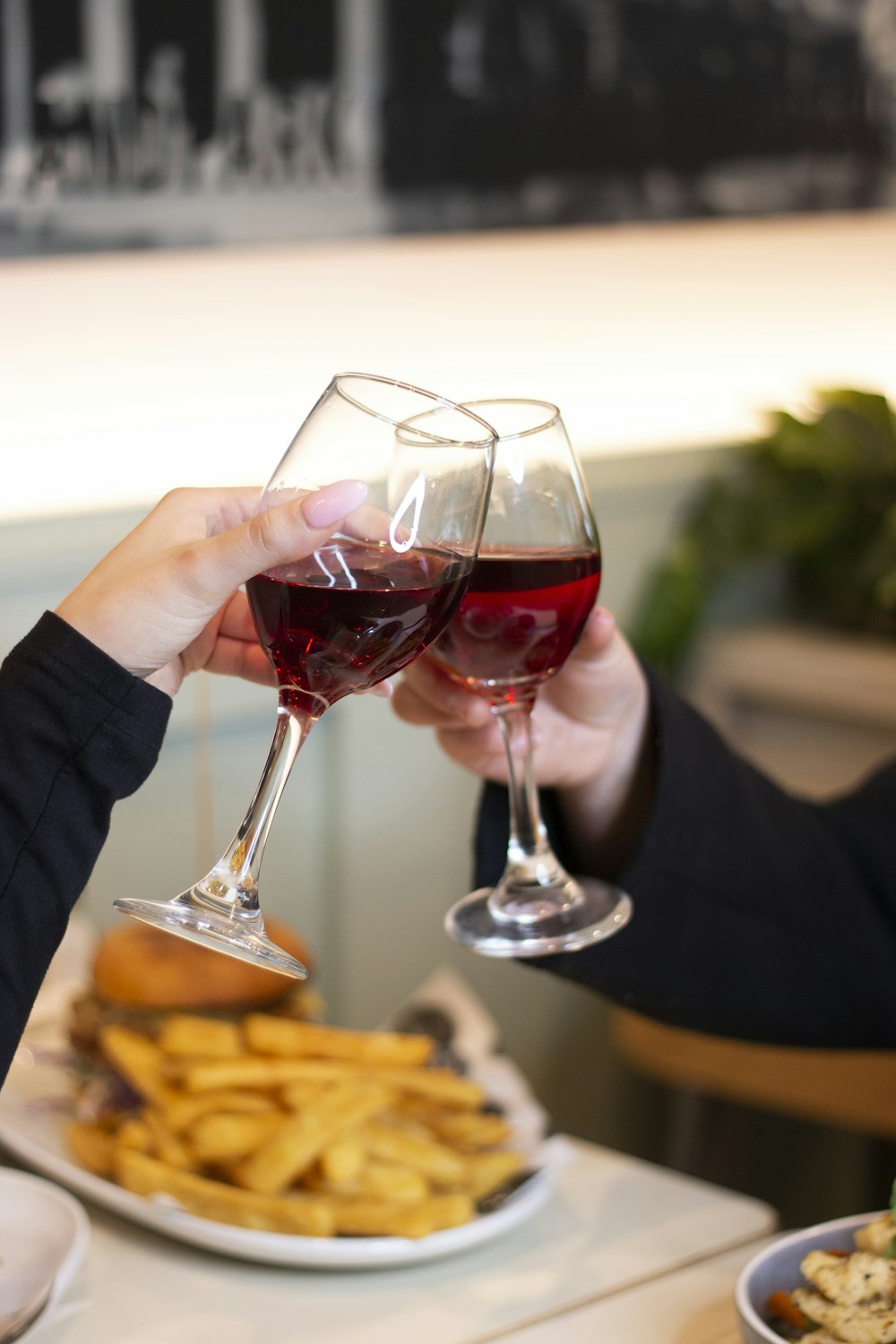 a couple of people holding wine glasses