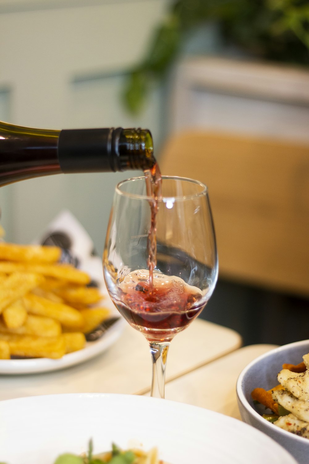 a glass of wine next to a plate of food